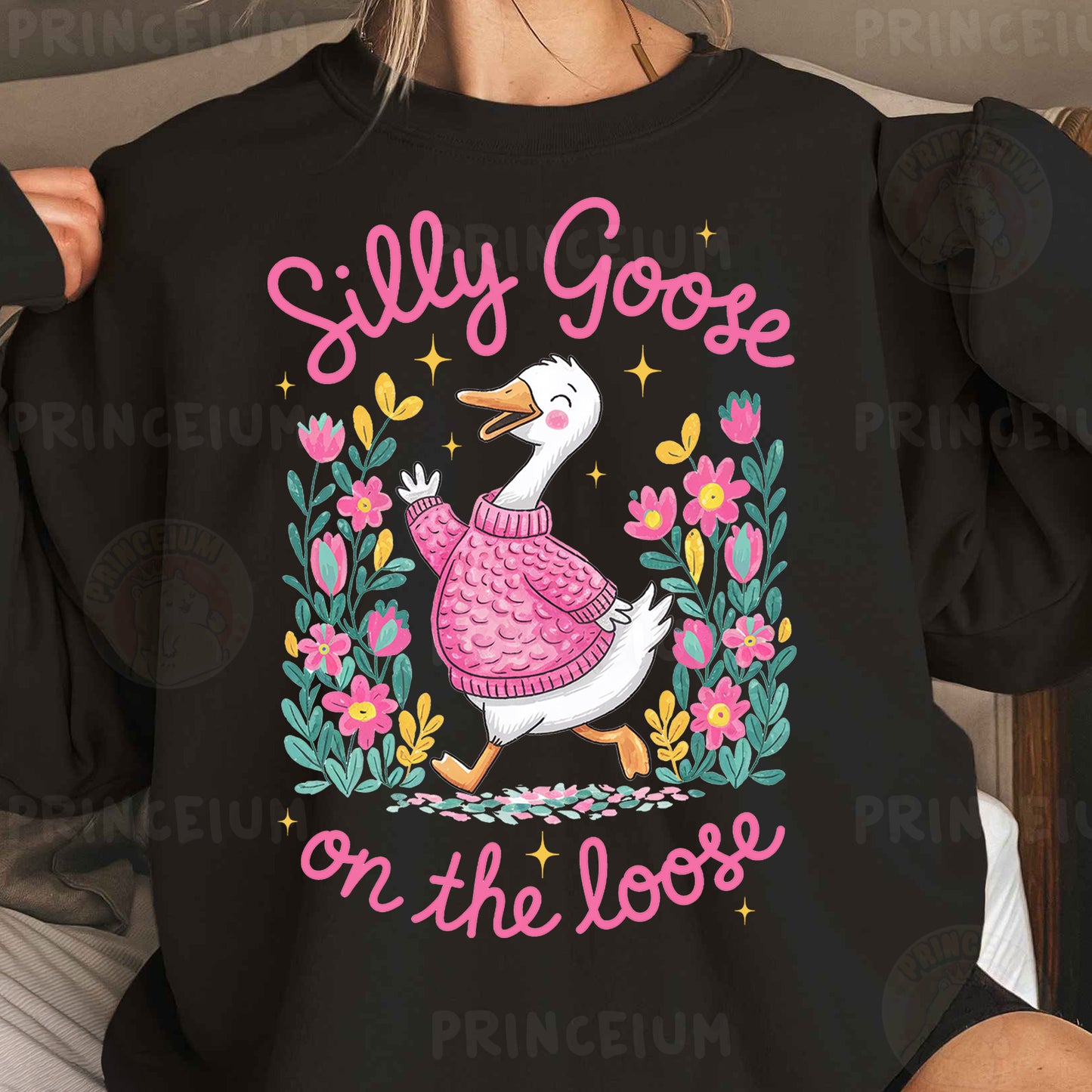 a woman wearing a black shirt with a pink duck on it