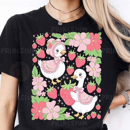 a woman wearing a black t - shirt with pink flowers and birds on it
