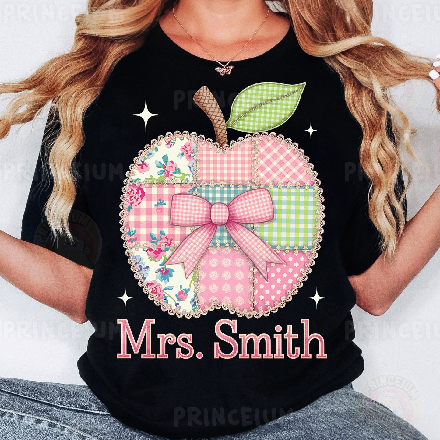 a woman wearing a black shirt with a pink apple on it