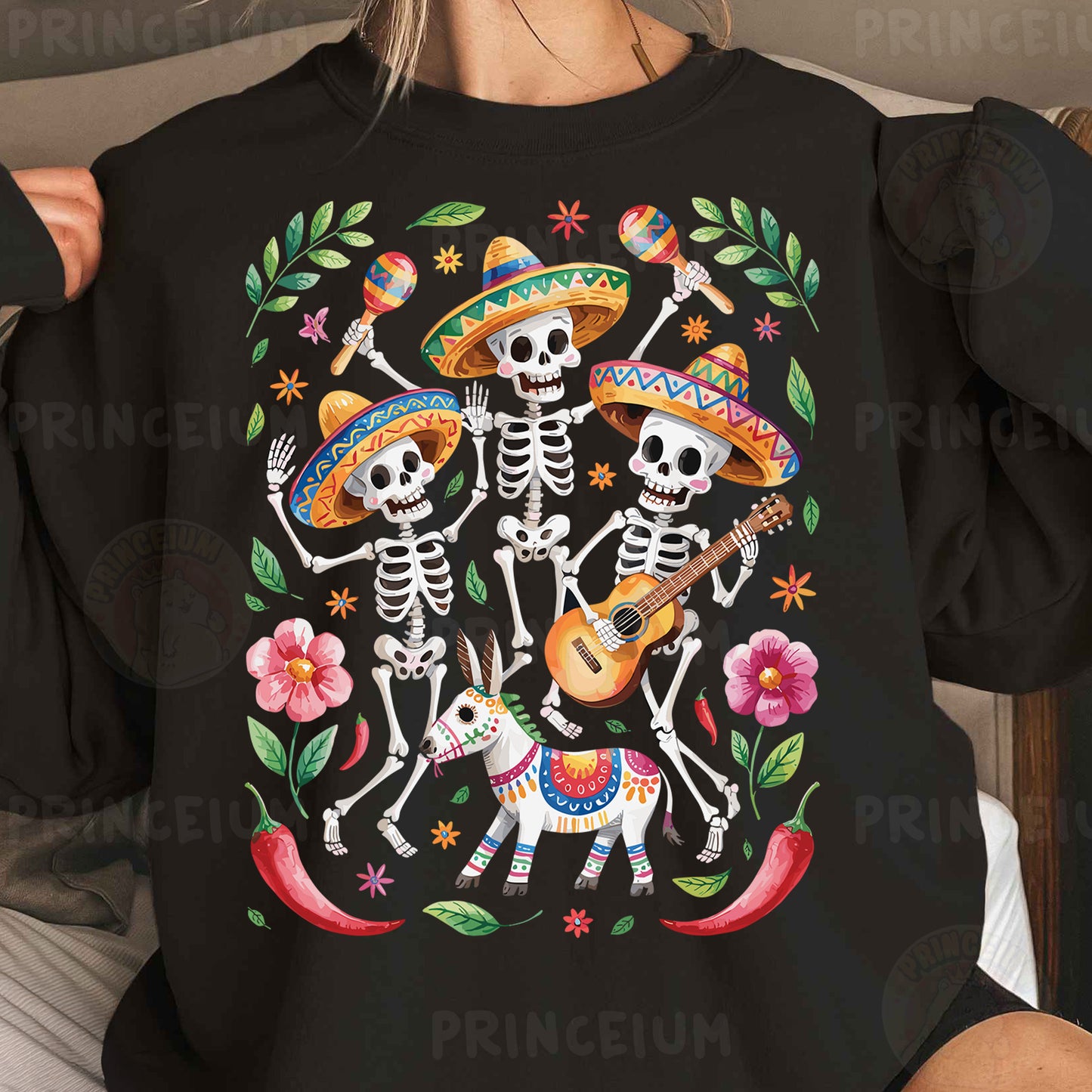 a woman wearing a black shirt with a mexican skeleton playing the guitar