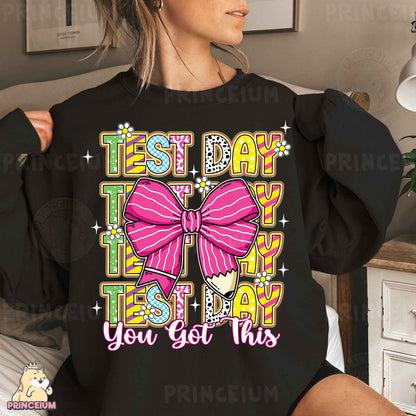 a woman wearing a black shirt with a pink bow on it
