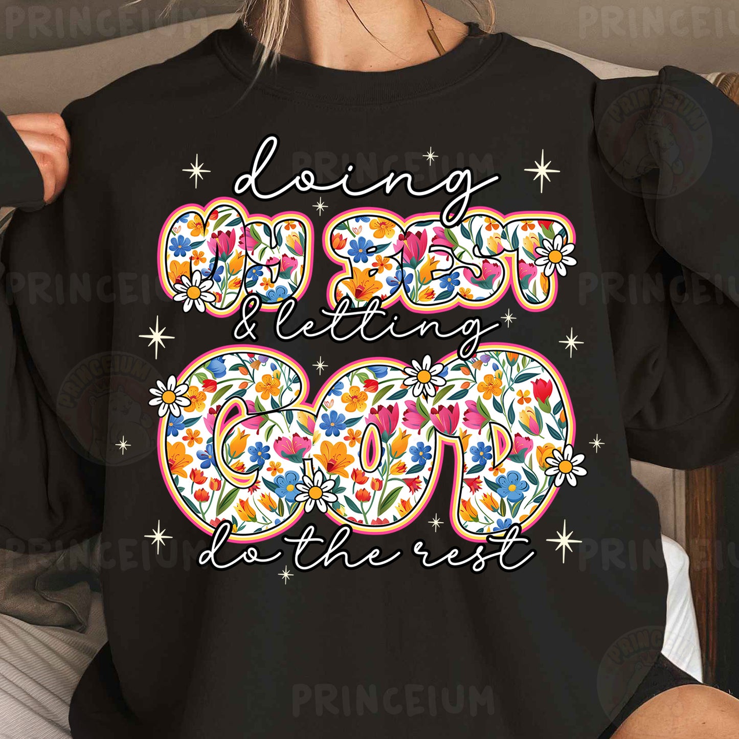 a woman wearing a black long sleeved shirt with a floral design