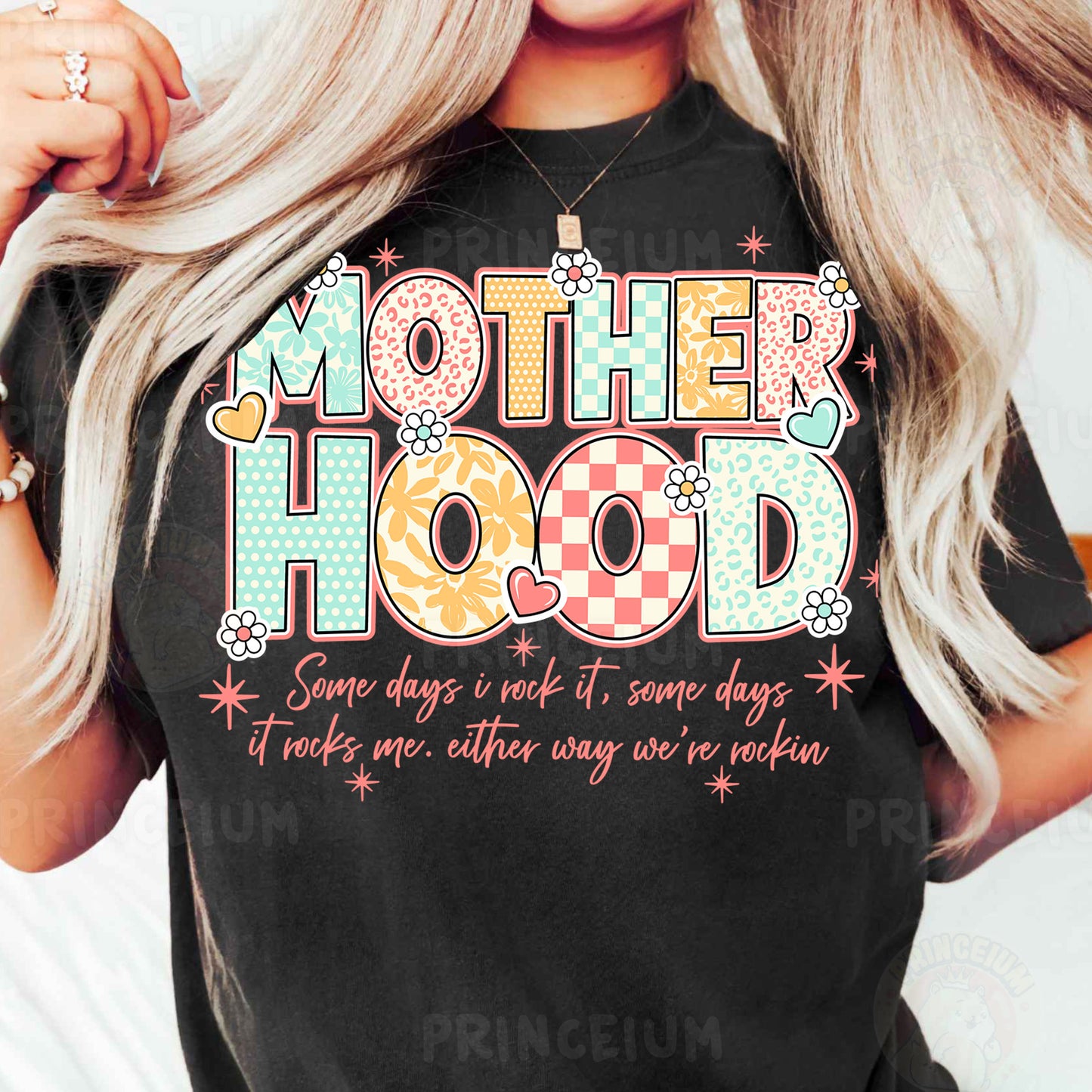 a woman wearing a t - shirt that says motherhood