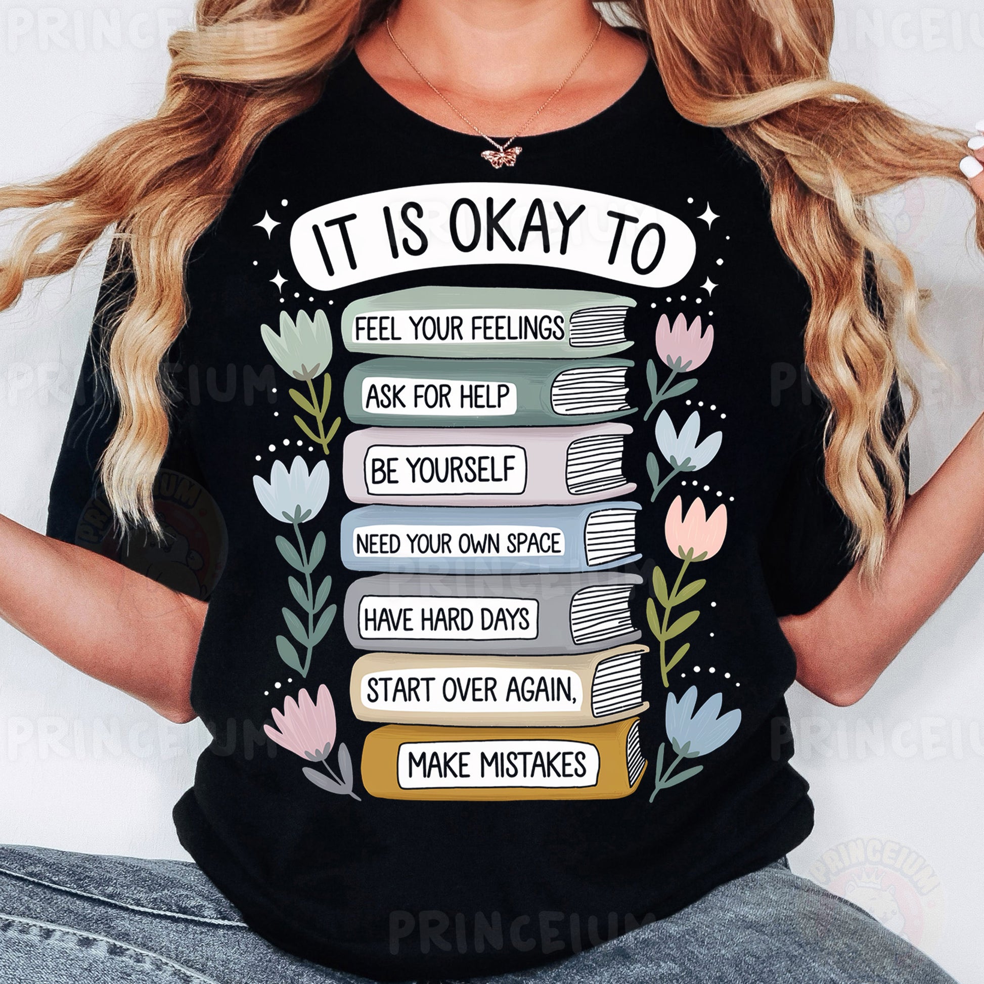 a woman wearing a t - shirt that says it is okay to read books