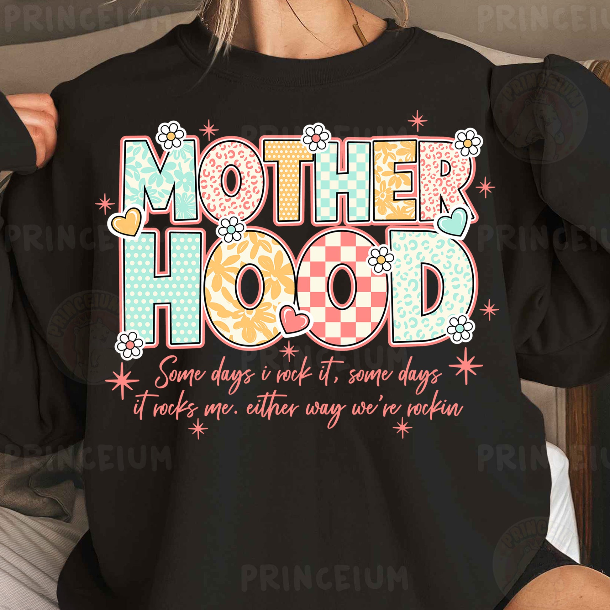 a woman wearing a black shirt that says motherhood