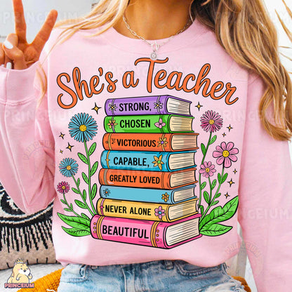 a woman wearing a pink shirt that says she's a teacher