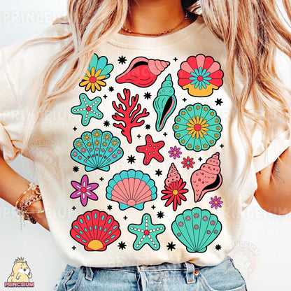 a woman wearing a t - shirt with a bunch of sea life on it