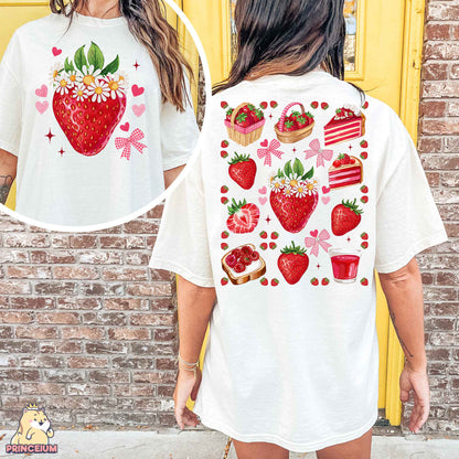 a woman wearing a white shirt with strawberries on it