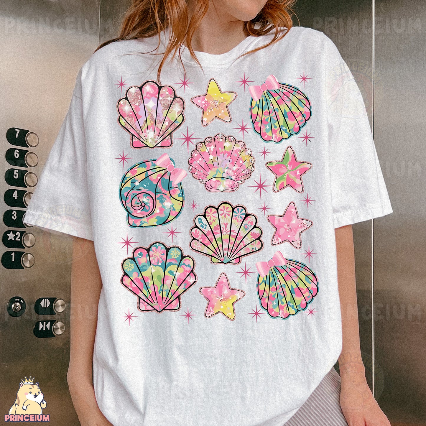 a woman wearing a t - shirt with seashells and stars on it
