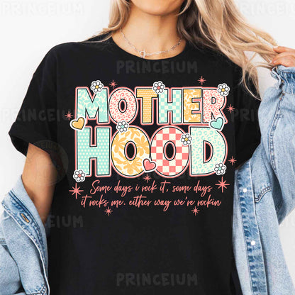 a woman wearing a t - shirt that says motherhood