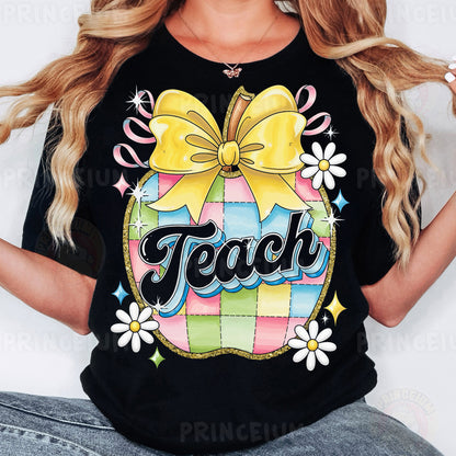 a woman wearing a black teacher shirt with a yellow bow