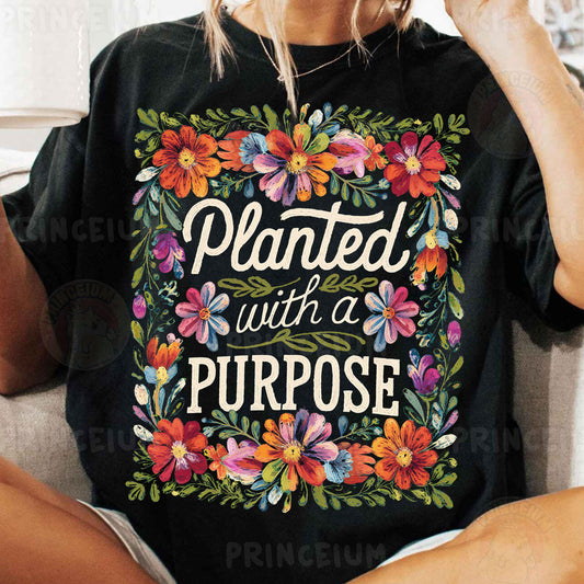 a woman sitting on a couch wearing a black shirt that says, planted with a