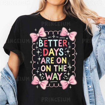a woman wearing a black t - shirt that says better days are on the way