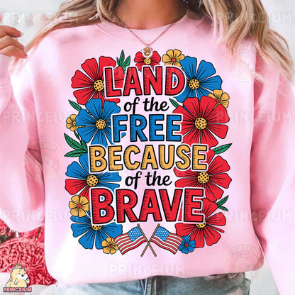 a woman wearing a pink sweatshirt that says land of the free because of the brave