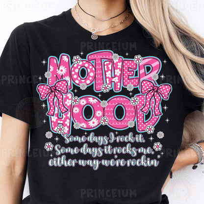a woman wearing a t - shirt that says motherhood