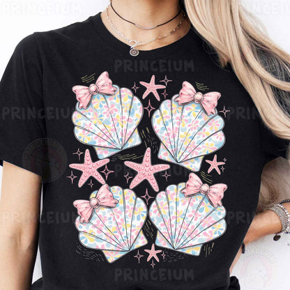 a woman wearing a black shirt with pink bows and seashells on it
