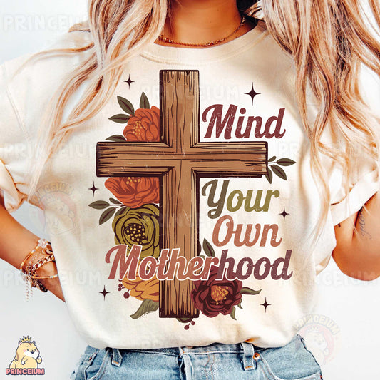 a woman wearing a t - shirt that says mind your own motherhood