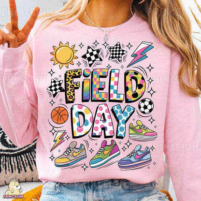 a woman wearing a pink sweatshirt that says field day