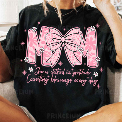 a woman sitting on a couch wearing a mom shirt