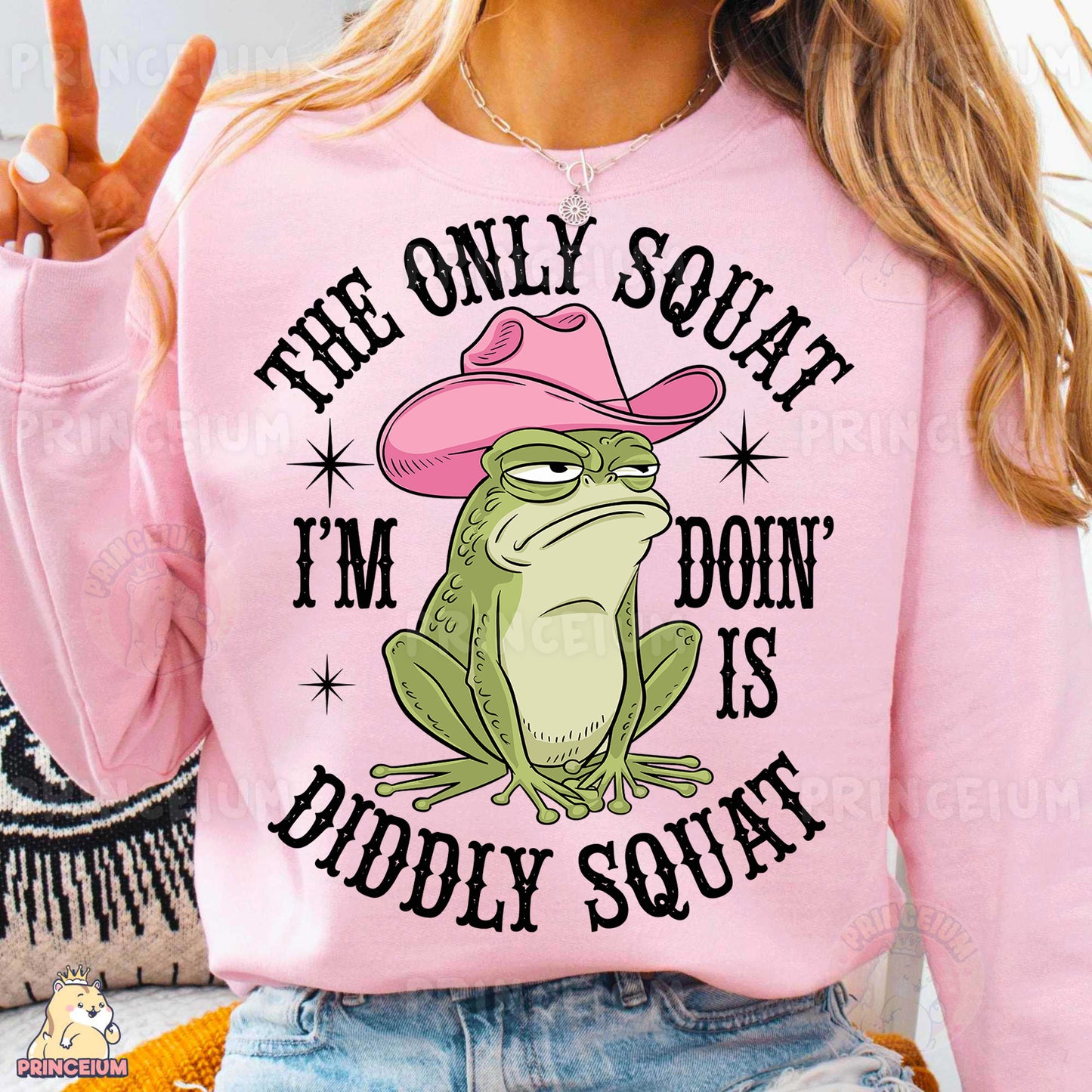 a woman wearing a pink shirt with a frog wearing a cowboy hat