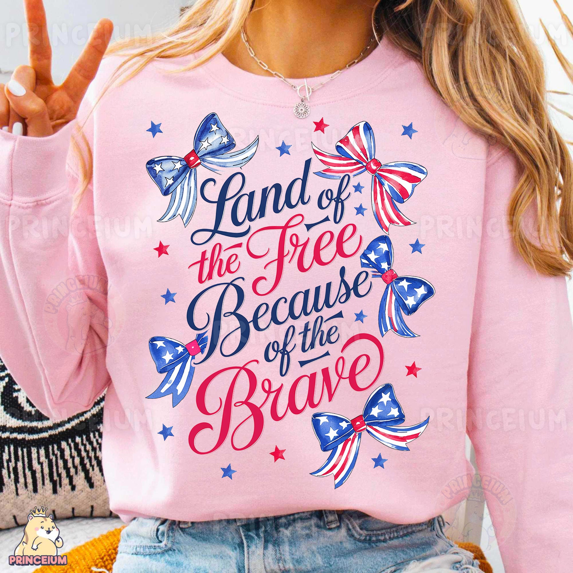 a woman wearing a pink shirt that says land of the free because of the brave