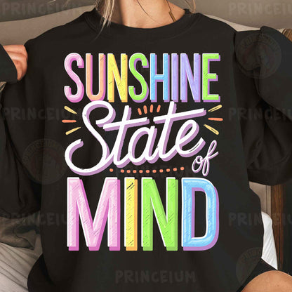 a woman wearing a black sweatshirt that says sunshine state of mind