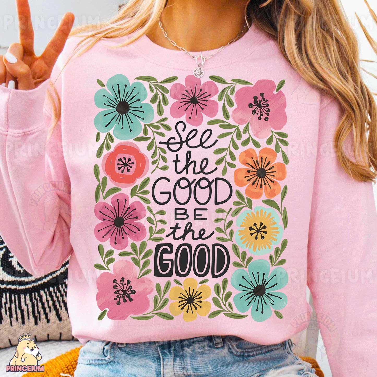 a woman wearing a pink sweatshirt with a floral design