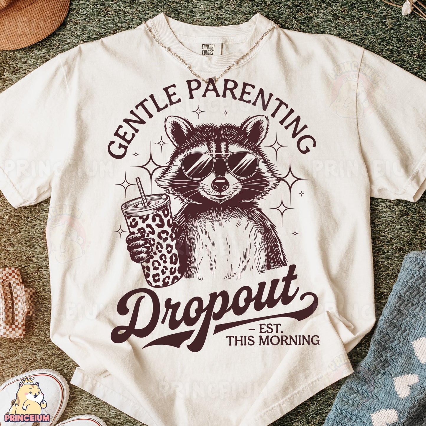 a t - shirt with a raccoon holding a drink