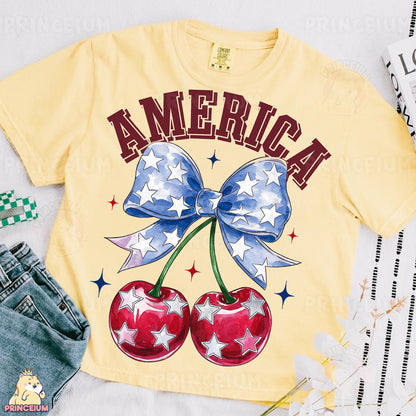 a t - shirt with a bow and two cherries on it