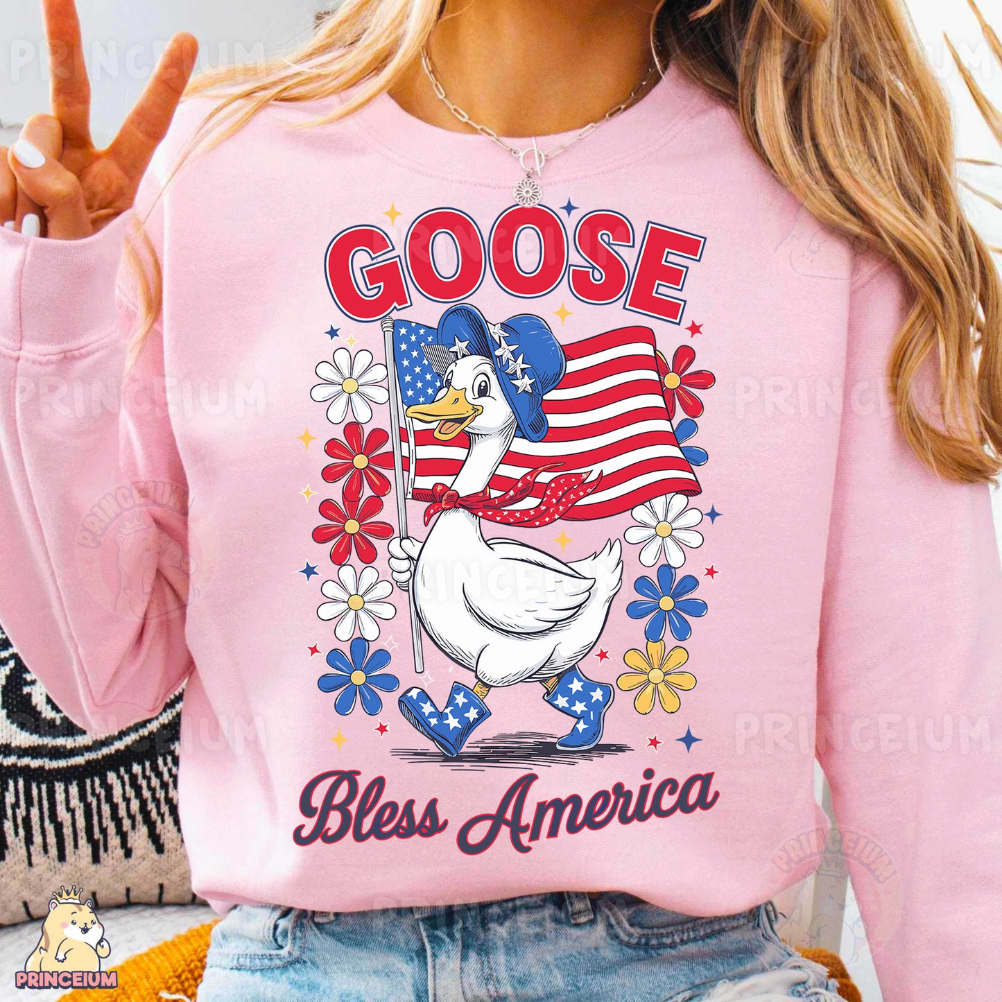 a woman wearing a pink goose sweatshirt with an american flag on it
