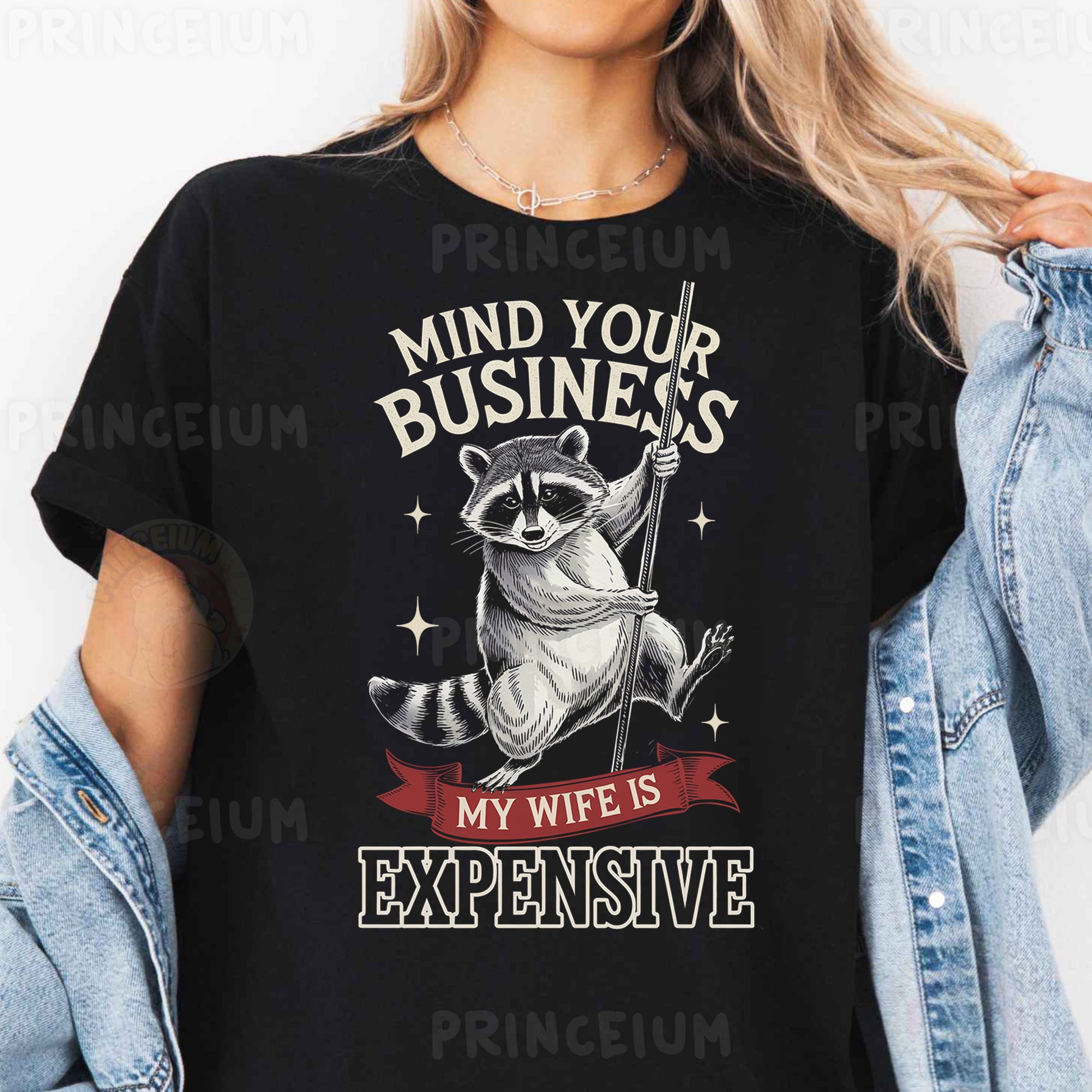 a woman wearing a black shirt with a raccoon saying mind your business my
