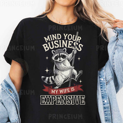 a woman wearing a black shirt with a raccoon saying mind your business my