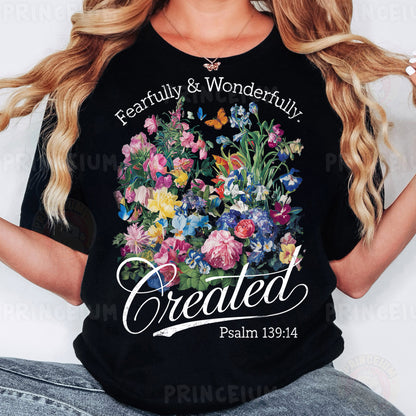 a woman wearing a black t - shirt with flowers on it