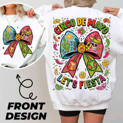 a woman wearing a white sweatshirt with a colorful bow