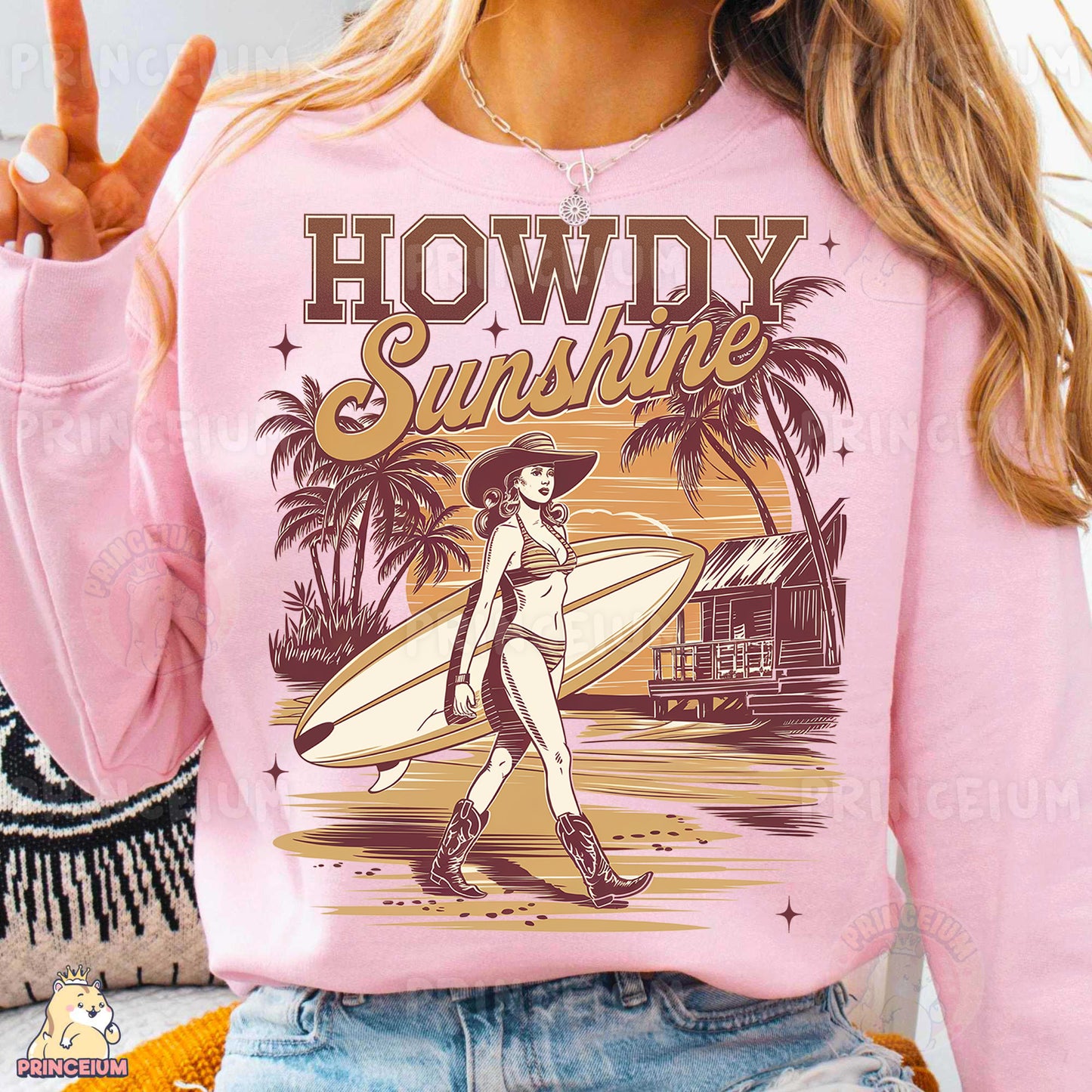 a woman wearing a pink sweatshirt with a graphic of a woman holding a surfboard