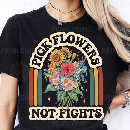 a woman wearing a black t - shirt that says pick flowers not fights