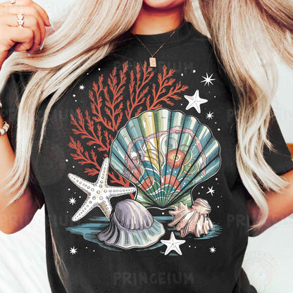 a woman wearing a black t - shirt with a seashell and starfish on