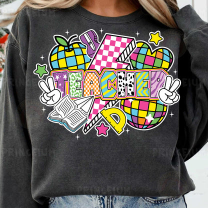 a woman wearing a black sweatshirt with a colorful graphic on it