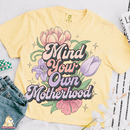 a t - shirt that says, mind your own motherhood