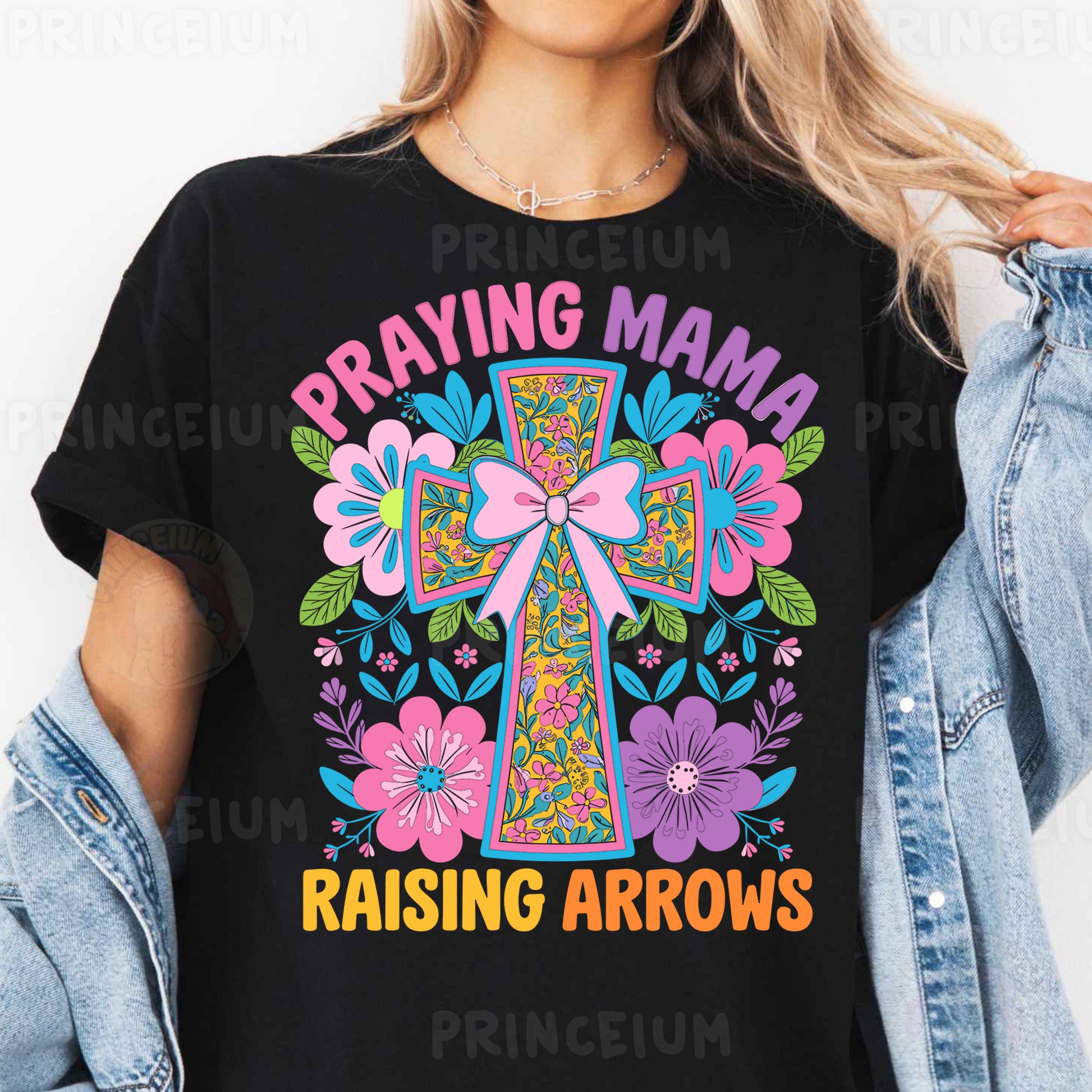 a woman wearing a black t - shirt that says praying mama raising arrows
