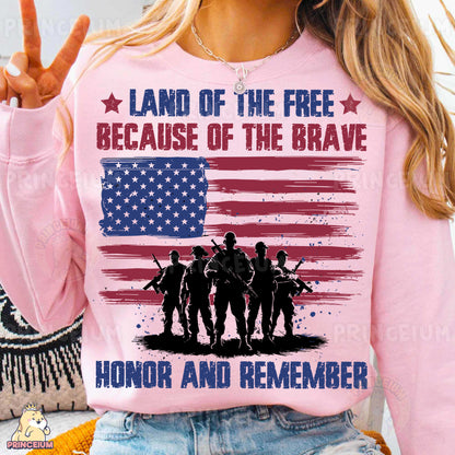 a woman wearing a pink shirt that says land of the free because of the brave