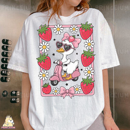 a woman wearing a t - shirt with a duck riding a scooter