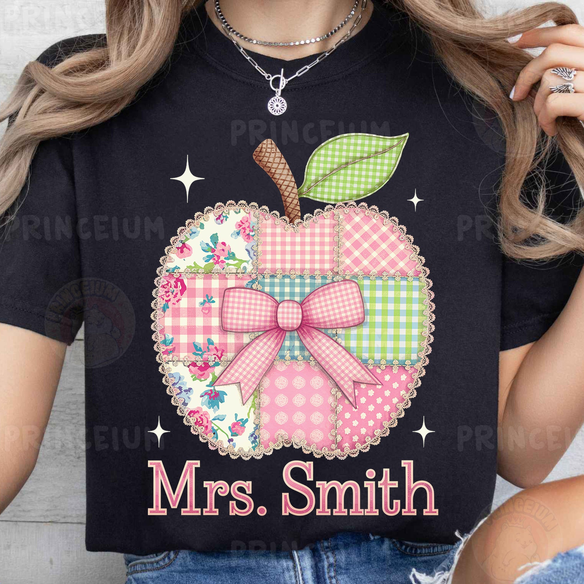 a woman wearing a black shirt with a pink apple on it