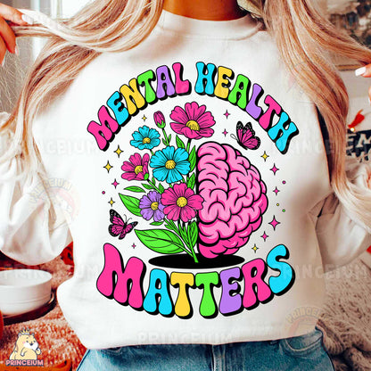 a woman wearing a white shirt with a flower brain on it