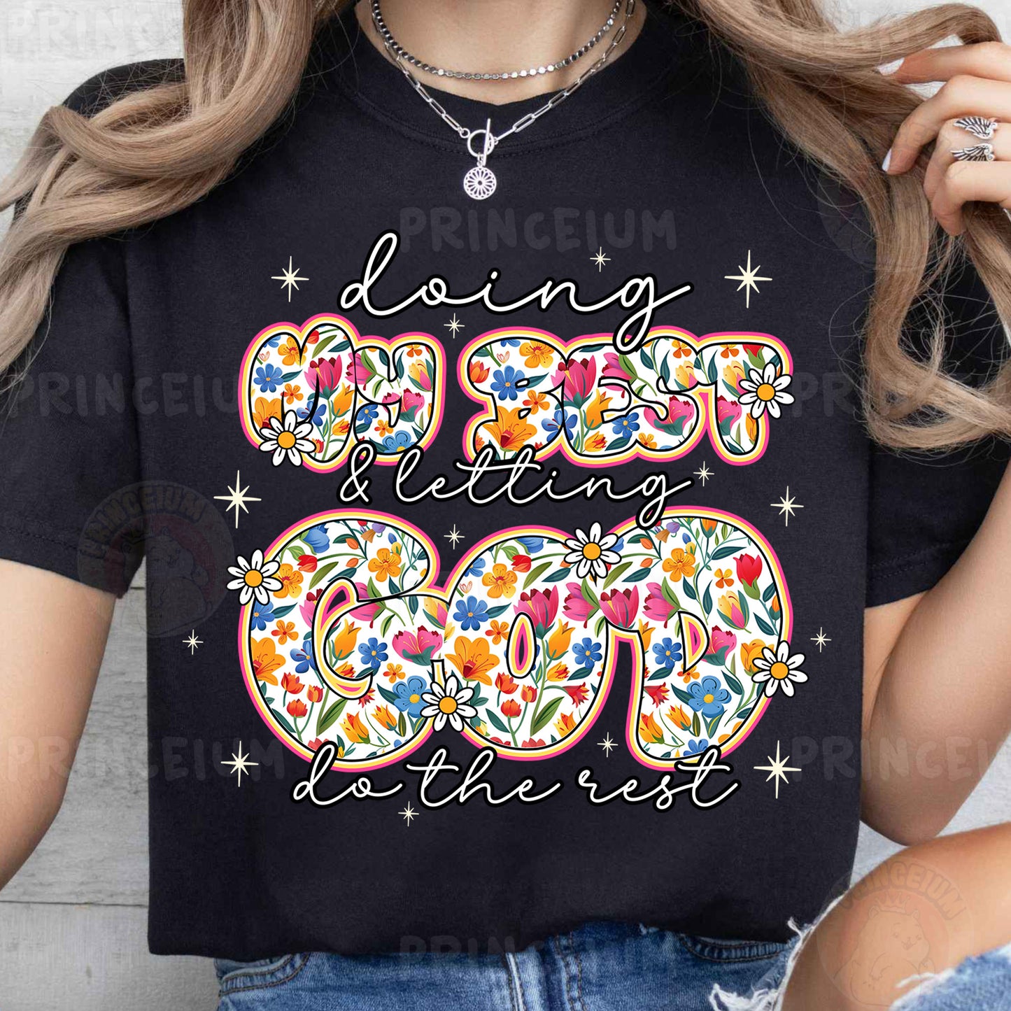 a woman wearing a black t - shirt with a floral design