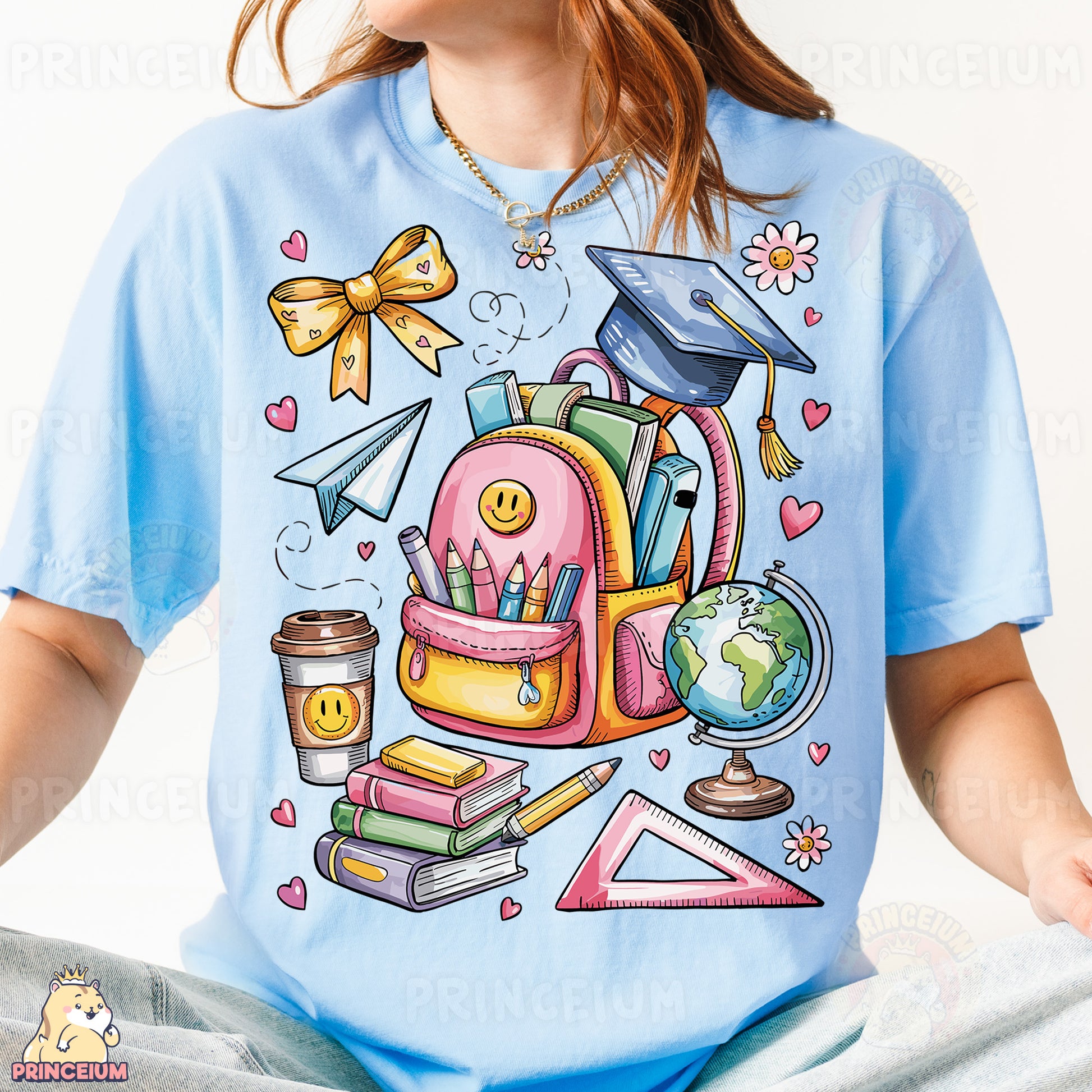 a girl wearing a blue shirt with a picture of a backpack and books on it