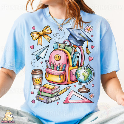 a girl wearing a blue shirt with a picture of a backpack and books on it
