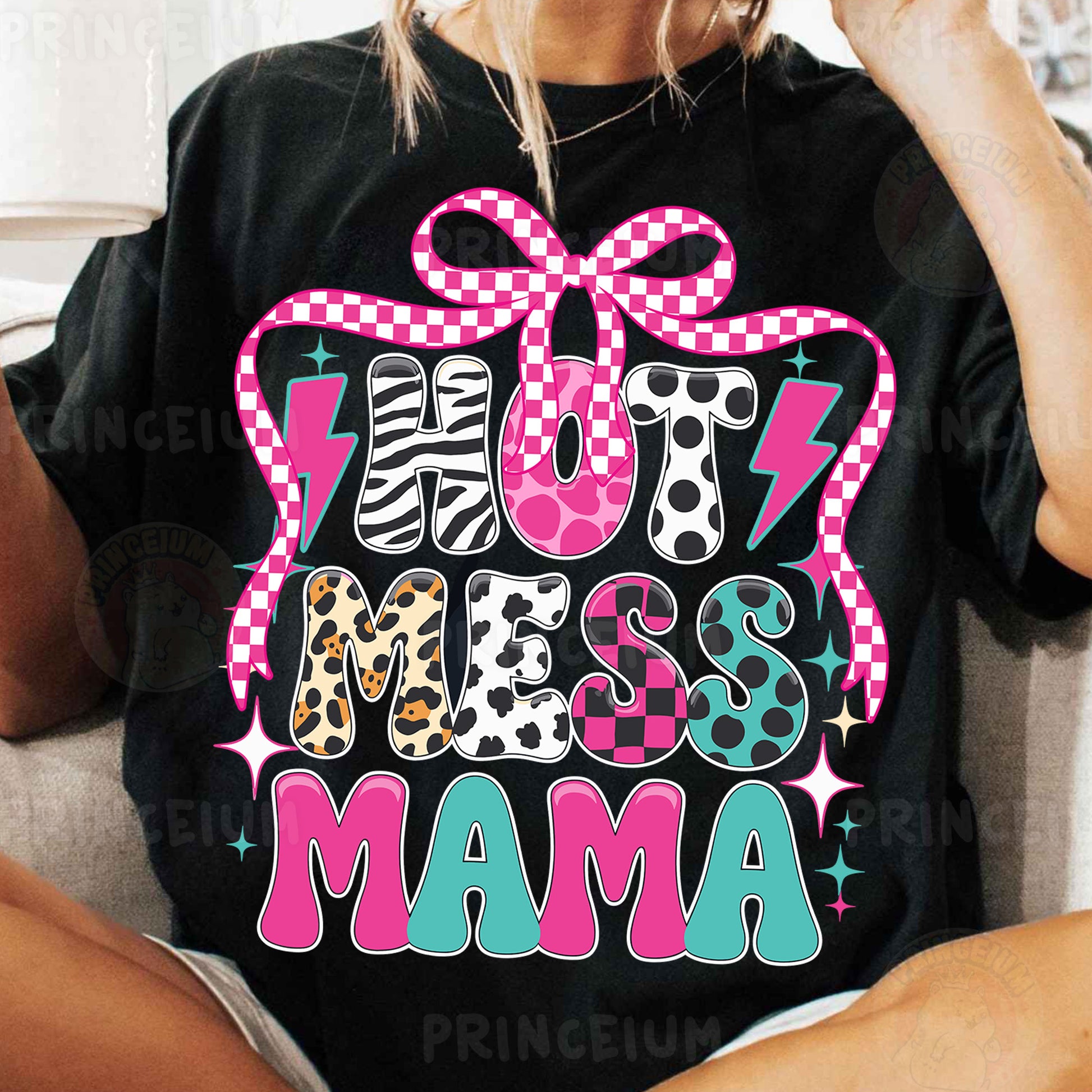 a woman sitting on a couch wearing a black shirt with a pink bow