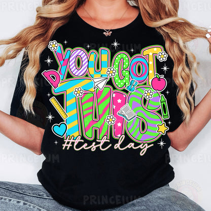 a woman wearing a black tshirt that says you got this first day