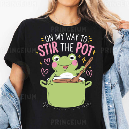 a woman wearing a black t - shirt that says on my way to stir the